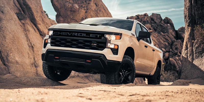 White Chevrolet Silverado Light Duty Truck Climbing a Hill