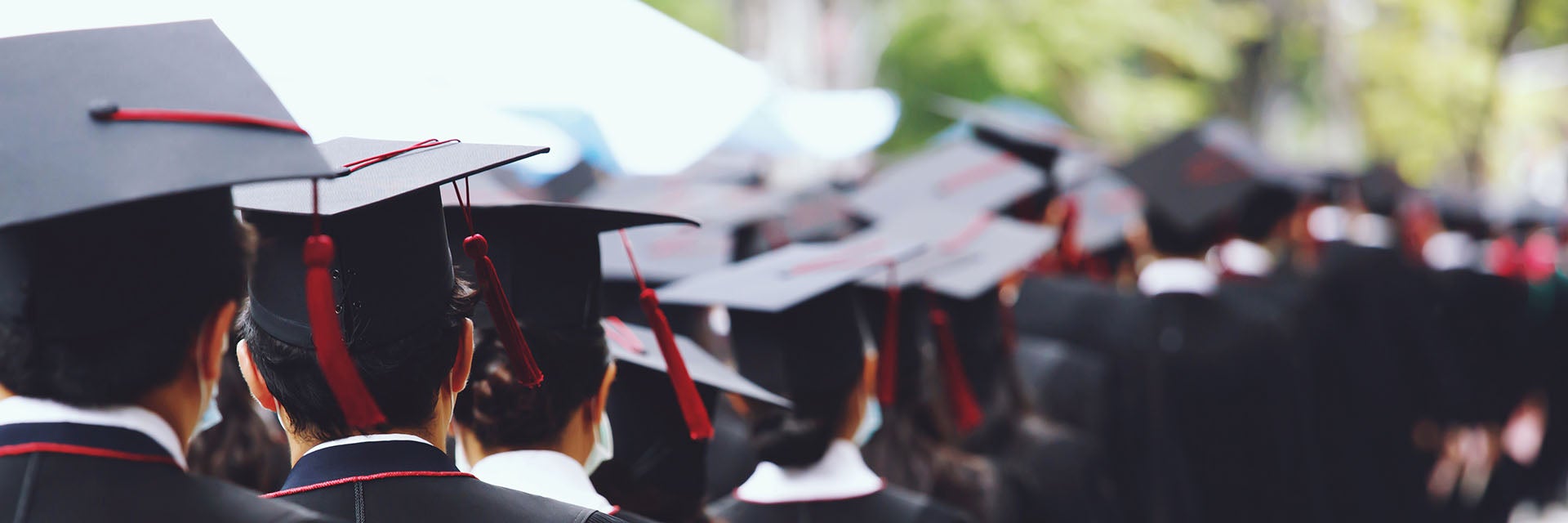 distributing degree at the festival, wearing a graduation cap