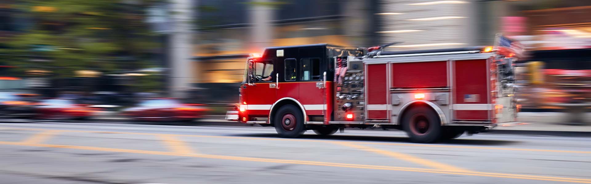 A fire truck is running on the road.